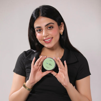 Woman holding a MAD container with a neutral background. Mad Care Teeth Whitening Powder 